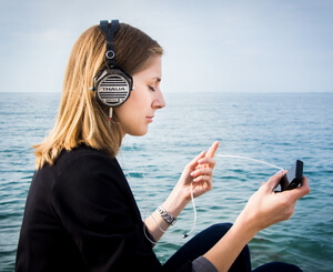 Woman listening to Dana Is Online podcast on her smart phone